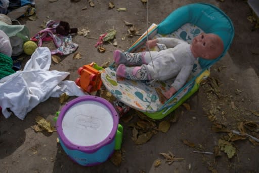 A baby doll is among the belongings left by those migrants who have abandoned the border camp