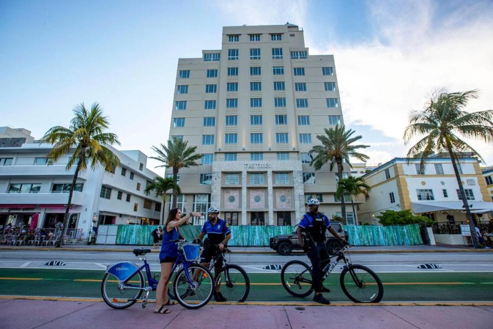 Tennessee resident Elizabeth Babcock, 39, speaks to City of Miami Bicycle Response Team members about directions while on Ocean Drive during the first day of Memorial Day Weekend in Miami Beach, Florida, on Friday, May 27, 2022.