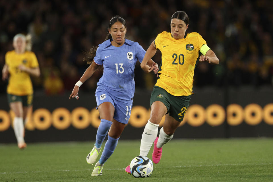 Australia's Sam Kerr, right, gets the ball past France's Selma Bacha during their friendly soccer match in Melbourne, Friday, July 14, 2023, ahead of the Women's World Cup. (AP Photo/Hamish Blair)