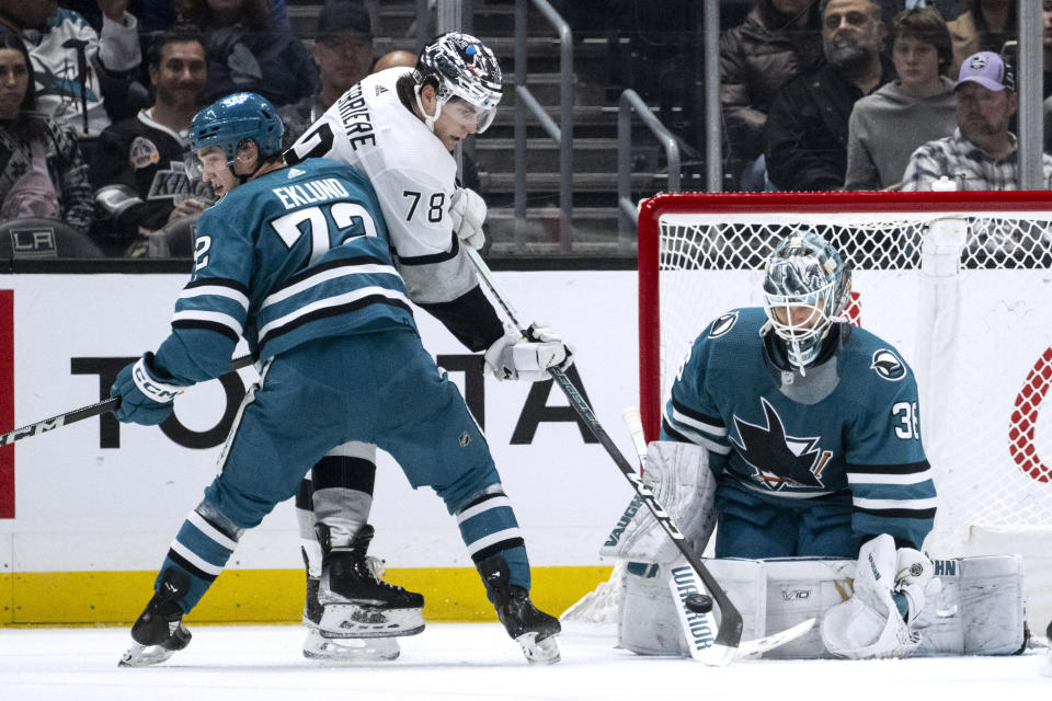 Los Angeles Kings right wing Alex Laferriere (78) deflects a shot in front of San Jose Sharks goaltender Kaapo Kahkonen (36) during the third period of an NHL hockey game Wednesday, Dec. 27, 2023, in Los Angeles. (AP Photo/Kyusung Gong)