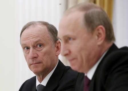 FILE PHOTO: Russian Security Council Secretary Nikolai Patrushev (L) looks at President Vladimir Putin during a meeting with the BRICS countries' senior officials in charge of security matters at the Kremlin in Moscow