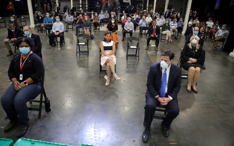 FILE PHOTO: Workers wait for U.S. President Donald Trump to speak at face mask production facility in Phoenix, Arizona