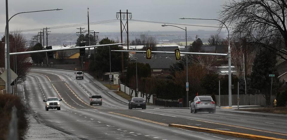 Motorists drive under new traffic signals that will soon be operational at the intersection of Columbia Center Boulevard and West 7th Avenue in Kennewick.
