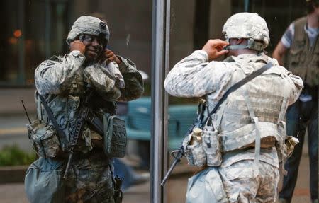 A National Guard soldier checks his reflection as soldiers set up around the city in preparation for potential protesting of the police shooting of Keith Scott in Charlotte, North Carolina, U.S. September 23, 2016. REUTERS/Jason Miczek