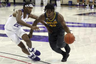 File-TCU guard RJ Nembhard (22) defends as Baylor guard Davion Mitchell (45) drives the ball past during a men's NCAA college basketball game, Saturday, Jan. 9, 2021. Mitchell and MaCio Teague, two of the league’s best shooters, were part of a Big 12-record 23-game winning streak last season in their debuts as Baylor starters. Those former transfers had also gone through a redshirt season together. (AP Photo/ Richard W. Rodriguez, File)