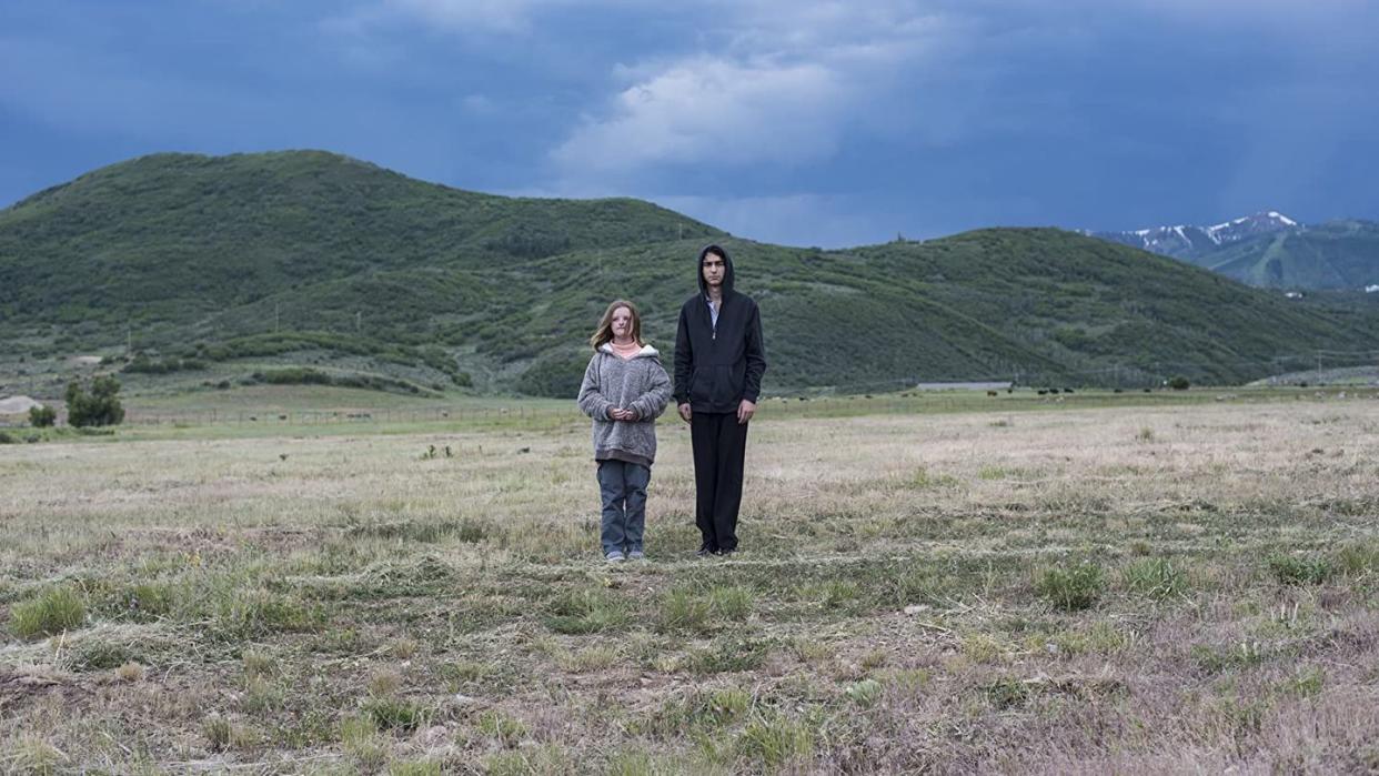 two kids stand in a field in a scene from hereditary a good housekeeping pick for best halloween movies