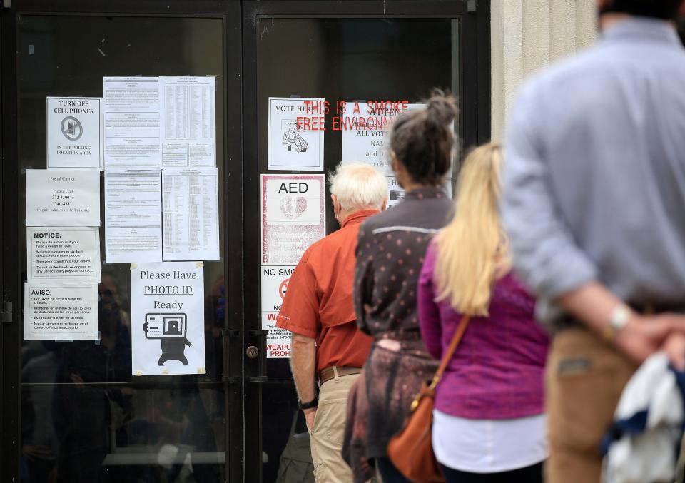 Voters stand in line at the Pulaski County Regional Building in downtown Little Rock, Arkansas on Oct. 19, 2020.