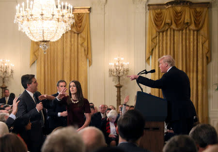 FILE PHOTO: A White House staff member reaches for the microphone held by CNN's Jim Acosta as he questions U.S. President Donald Trump during a news conference following Tuesday's midterm U.S. congressional elections at the White House in Washington, U.S., November 7, 2018. REUTERS/Jonathan Ernst/File Photo