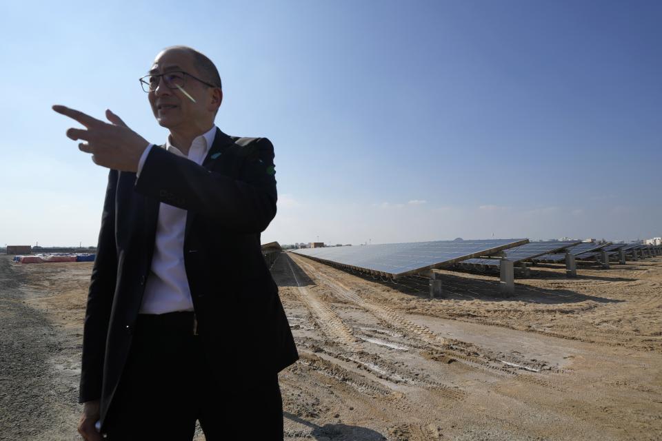 Chris Wan, associate director of sustainability at Masdar City speaks in the near solar panels near Abu Dhabi, United Arab Emirates, as Dubai hosts the COP28 U.N. Climate Summit, Friday, Dec. 8, 2023. (AP Photo/Kamran Jebreili)