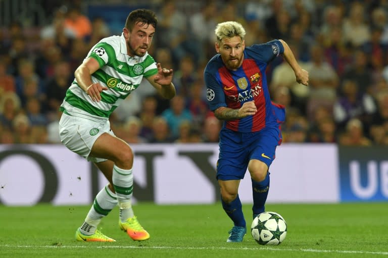 Celtic lost 7-0 in their opening Group C match to Barcelona as their defence was torn apart by the Spanish champions' forward line of Lionel Messi (R), Luis Suarez and Neymar