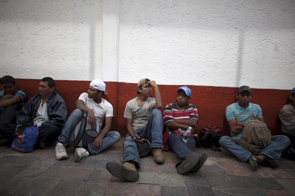 In this May 17, 2012 photo, migrants sit outside the mayor's residence after protesting violence against migrants in Lecheria, on the outskirts of Mexico City. While the number of Mexicans heading to the U.S. has dropped dramatically, a surge of Central American migrants is making the 1,000-mile northbound journey this year, fueled in large part by the rising violence brought by the spread of Mexican drug cartels. (AP Photo/Alexandre Meneghini)