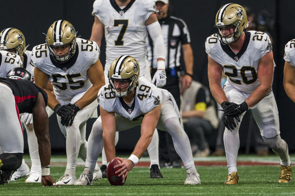 New Orleans Saints long snapper Zach Wood (49), linebacker Kaden Elliss (55), and linebacker Pete Werner (20) line up in punt formation during the first half of an NFL football game against the Atlanta Falcons, Sunday, Sep. 11, 2022, in Atlanta. The New Orleans Saints won 27-26. (AP Photo/Danny Karnik)
