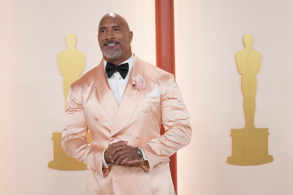 Dwayne Johnson arrives at the Oscars on Sunday, March 12, 2023, at the Dolby Theatre in Los Angeles. (AP Photo/Ashley Landis)