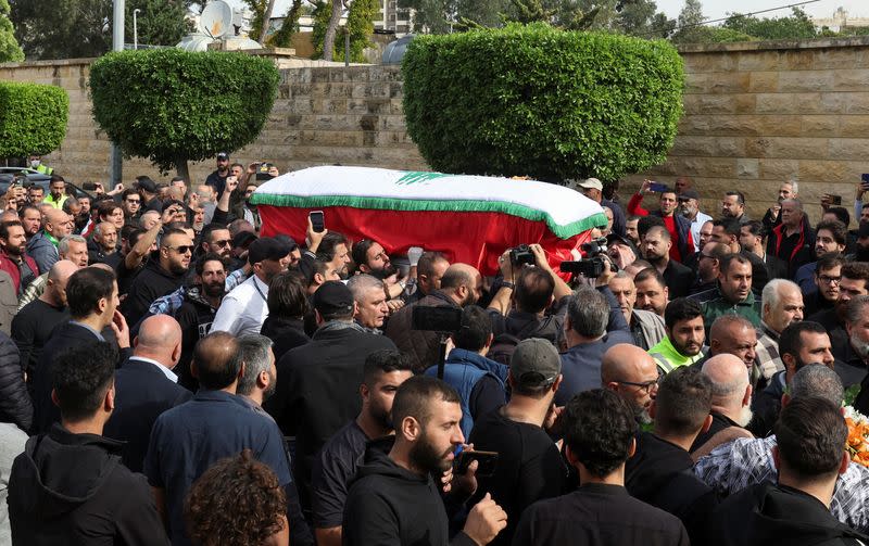 People carry the coffin of Rabih al-Memari during his funeral in Beirut