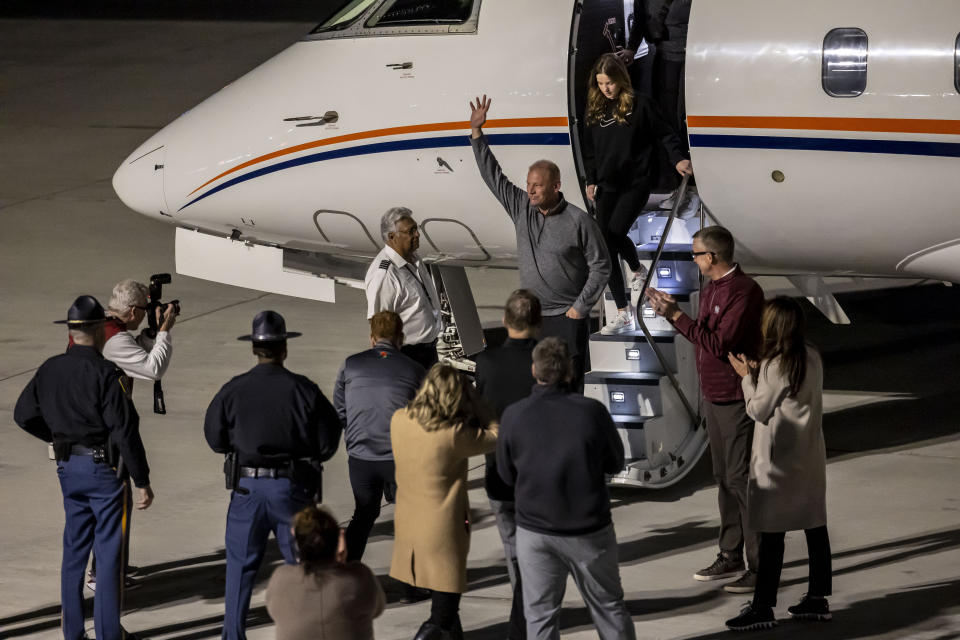 New Alabama football head coach Kalen DeBoer, center, waves to cheering fans as he steps off the plane at Tuscaloosa National Airport two days after former coach Nick Saban announced his retirement Friday, Jan. 12, 2024, in Tuscaloosa, Ala. (AP Photo/Vasha Hunt)