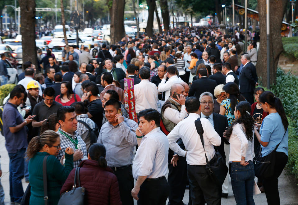 <p>People stand along Reforma Avenue after a 7.2-magnitude earthquake shook Mexico City, Friday, Feb. 16, 2018. (Photo: Marco Ugarte/AP) </p>