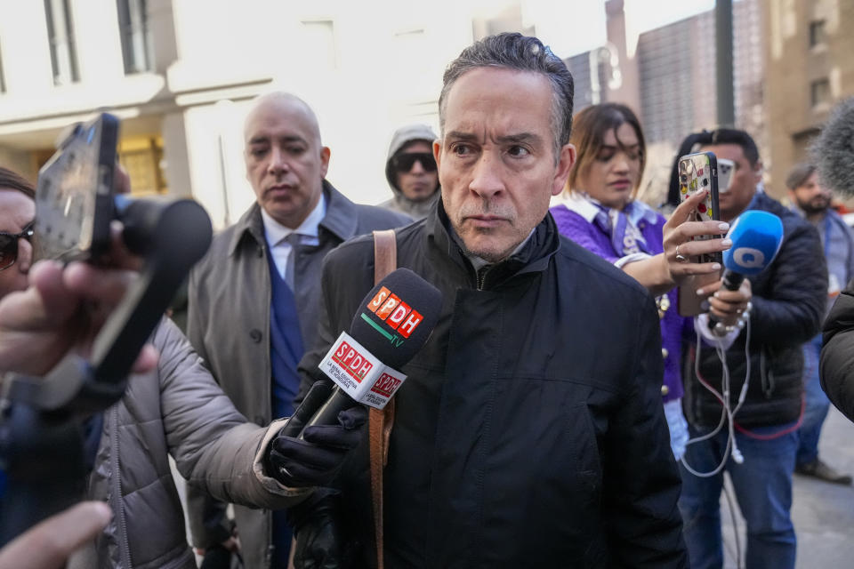 Raymond Colon, lawyer for former Honduran President Juan Orlando Hernandez, is surrounded by reporters as he leaves Federal court, Friday, March 8, 2024, in New York. Former Honduran President Juan Orlando Hernandez has been convicted in New York of conspiring with drug traffickers, his military and police to enable tons of cocaine to reach the United States. (AP Photo/Mary Altaffer)