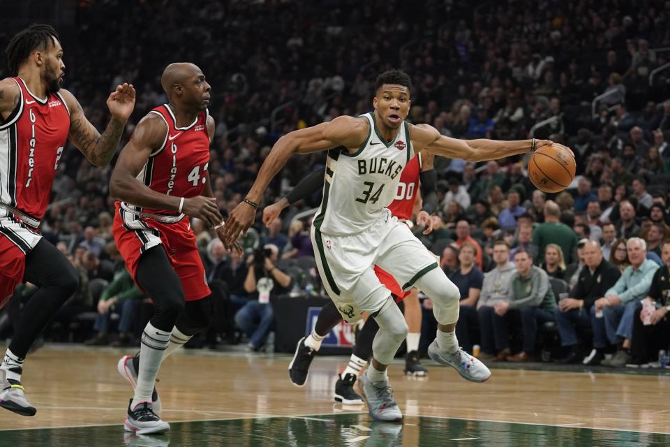 Milwaukee Bucks' Giannis Antetokounmpo drives past Portland Trail Blazers' Anthony Tolliver during the first half of an NBA basketball game Thursday, Nov. 21, 2019, in Milwaukee. (AP Photo/Morry Gash)