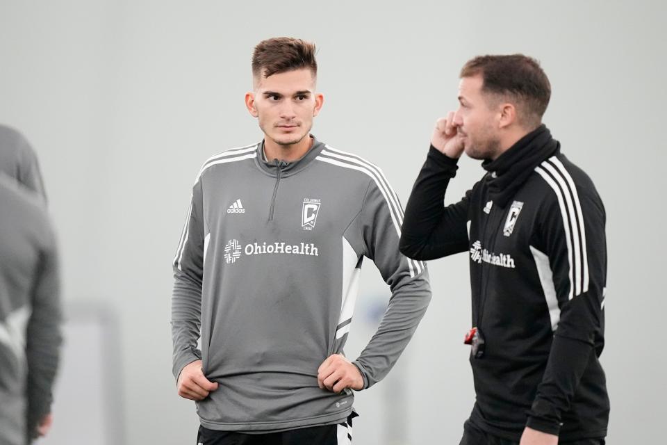 Jan 11, 2023; Columbus, Ohio, USA;  Columbus Crew homegrown player Keegan Hughes, a Heath graduate, listens to assistant coach Yoann Damet during training at the OhioHealth Performance Center. Mandatory Credit: Adam Cairns-The Columbus Dispatch