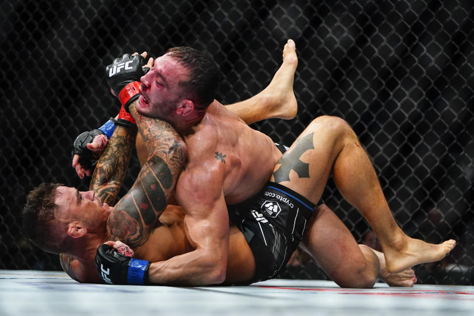 Michael Chandler, above, grapples with Dustin Poirier during the second round of a lightweight bout at the UFC 281 mixed martial arts event, Saturday, Nov. 12, 2022, in New York. Poirier stopped Chandler in the third round. (AP Photo/Frank Franklin II)