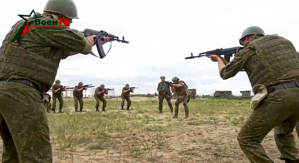 In this photo taken from video released by Belarusian Defense Ministry via VoenTV on Friday, July 14, 2023, Belarusian soldiers attend a training by mercenary fighters from Wagner private military company near Tsel village, about 90 kilometers (about 55 miles) southeast of Minsk, Belarus. Mercenary fighters from the Wagner private military company are training Belarusian soldiers in Belarus, the country's Defense Ministry said Friday. Russian President Vladimir Putin said he offered the Wagner private military company the option of continuing to serve as a single unit under their same commander. (Belarusian Defense Ministry via VoenTV via AP)