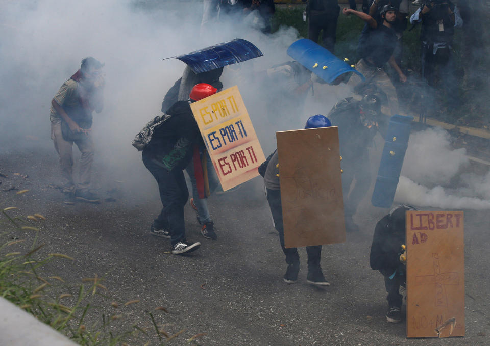 <p>Demonstrators using makeshift shields clash with police during rally against Venezuela’s President Nicolas Maduro in Caracas, Venezuela May 1, 2017. (Photo: Carlos Garcia Rawlins/Reuters) </p>