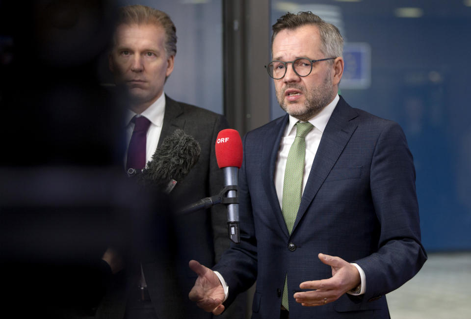 German Minister of State for European Affairs Michael Roth, right, speaks with the media as he arrives for a General Affairs Council meeting at the Europa building in Brussels, Tuesday, Dec. 11, 2018. Top European Union officials ruled out Tuesday any renegotiation of the divorce agreement with Britain as Prime Minister Theresa May launched her fight to save her Brexit deal by lobbying leaders in Europe's capitals. (AP Photo/Virginia Mayo)