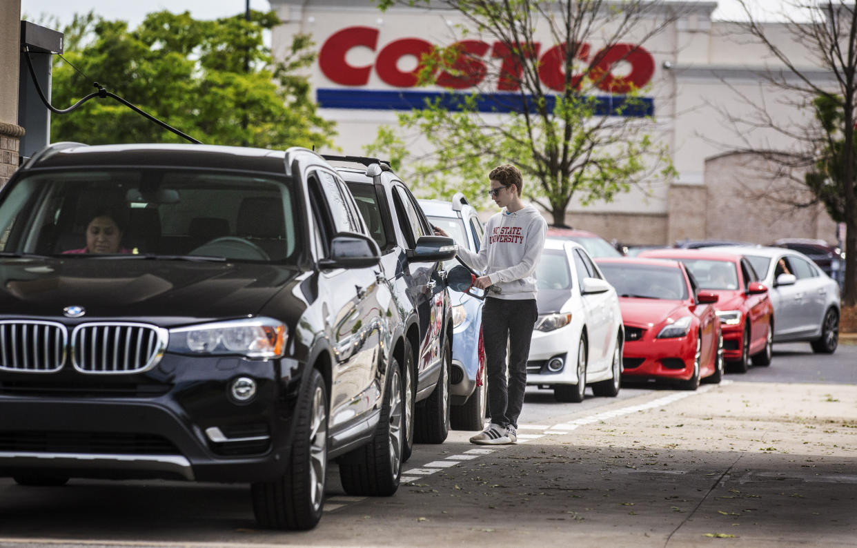 Numerous vehicles line up for gasoline at Costco on Wendover Avenue in Greensboro, N.C., on Tuesday, May 11, 2021. As the shutdown of a major fuel pipeline entered into its fifth day, efforts are under way to stave off potential fuel shortages, though no widespread disruptions were evident. The Colonial Pipeline, which delivers about 45% of the fuel consumed on the East Coast, was hit by a cyberattack on Friday. (Woody Marshall/News & Record via AP)