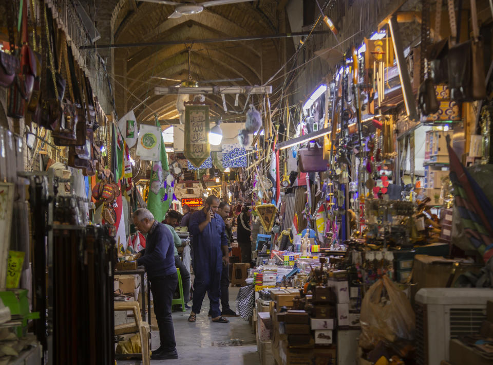 People shop in Al Sarai antiques market in Baghdad, Iraq, Saturday, Feb. 19, 2022. (AP Photo/Hadi Mizban)