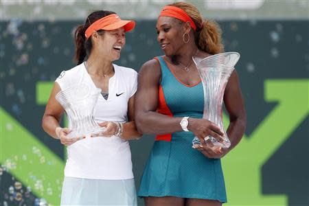 Mar 29, 2014; Miami, FL, USA; Serena Williams (right) holds the championship trophy as Li Na (left) holds the runner-up trophy after the final of the Sony Open at Crandon Tennis Center. Williams won 7-5, 6-1. Mandatory Credit: Geoff Burke-USA TODAY Sports