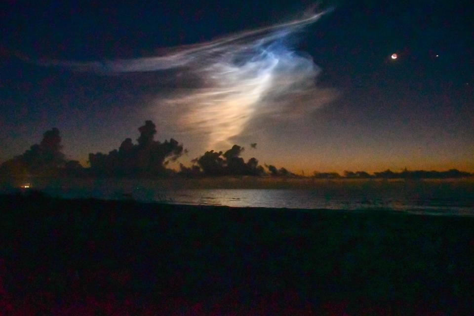 After the launch of a SpaceX Falcon 9 rocket on Starlink 8-9 mission, the contrail hung in the sky like a ghost next to the waning Strawberry moon and Jupiter.