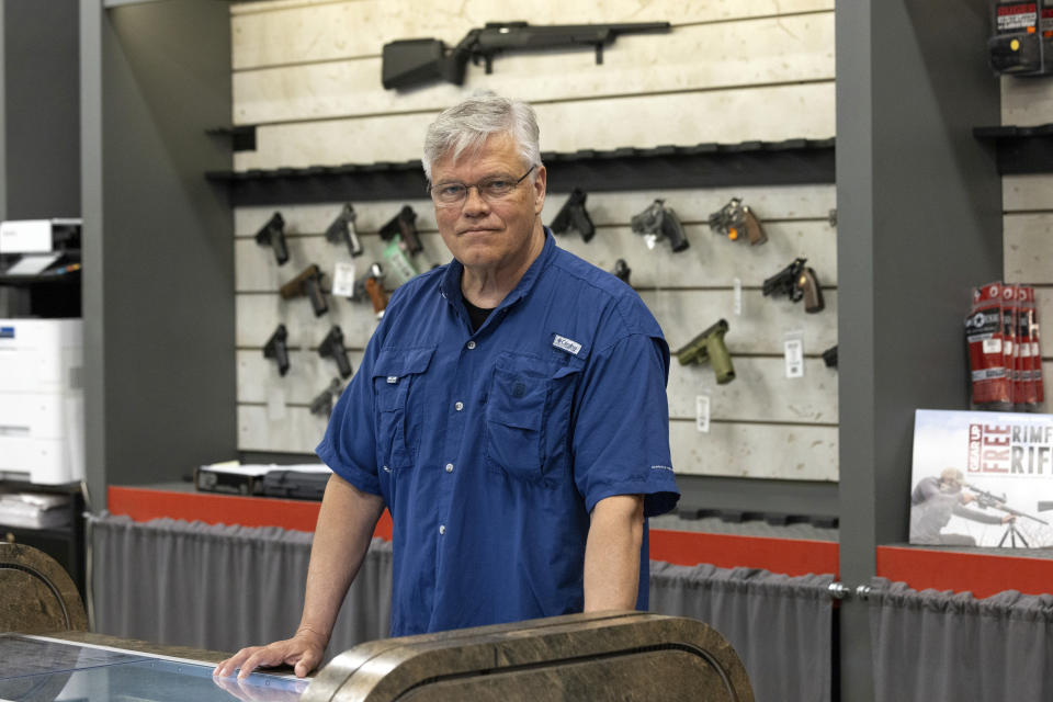 Maxon Shooter's Supplies owner Dan Eldridge poses in his store in Des Plaines, Ill., Tuesday, June 25, 2024. A new national divide is emerging among states over whether to track sales by gun stores. A California law taking effect Monday will require credit card networks to provide banks with special retail codes to assign to gun stores. By contrast, new laws taking effect in Georgia, Iowa, Tennessee and Wyoming will prohibit the use of special gun shop codes in financial transactions. A total of 17 states have passed some sort of limit on category codes for gun retailers, while California has been joined by Colorado and New York. (AP Photo/Teresa Crawford)