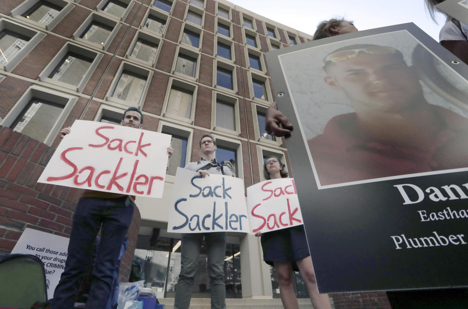 FILE - Protesters gather outside a courthouse on Friday, Aug. 2, 2019, in Boston, where a judge was to hear arguments in Massachusetts' lawsuit against Purdue Pharma over its role in the national drug epidemic. Purdue and state, local and Native American tribal governments across the U.S. agreed to settle lawsuits over the toll of opioids more than a year ago, but the money isn't flowing yet because of a wait for a key court ruling. (AP Photo/Charles Krupa, File)