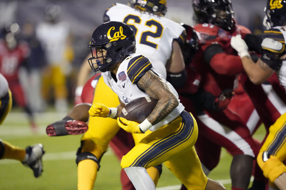 California running back Jaydn Ott (1) runs for a first down against Texas Tech during the first half of the Independence Bowl NCAA college football game Saturday, Dec. 16, 2023, in Shreveport, La. (AP Photo/Rogelio V. Solis)