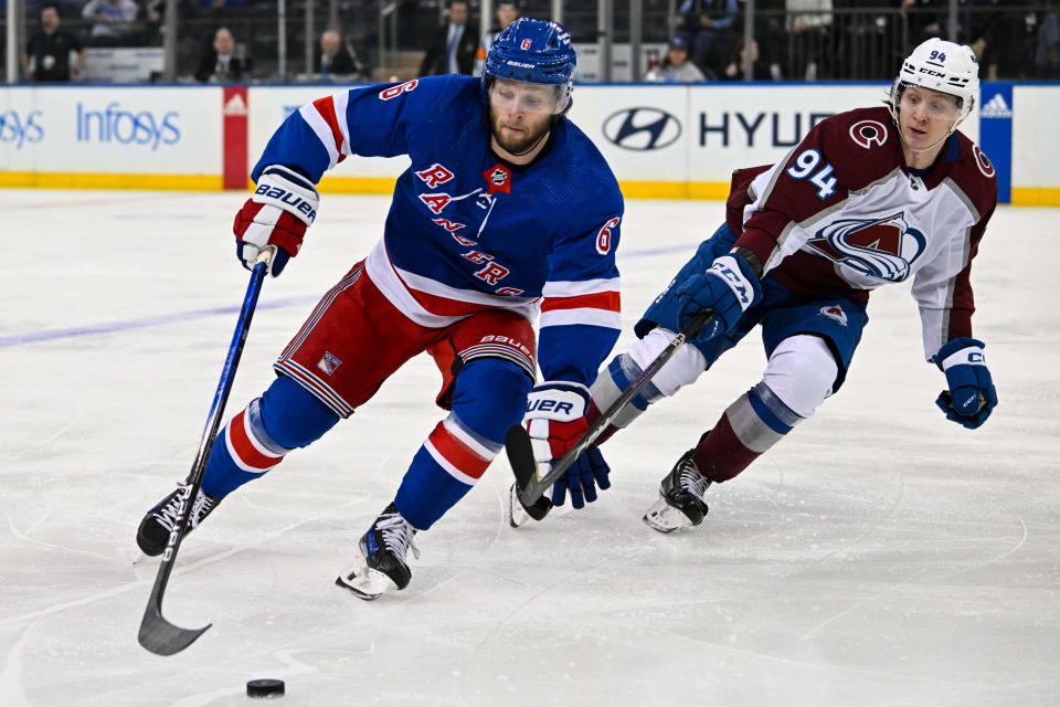 Feb 5, 2024; New York, New York, USA; New York Rangers defenseman Zac Jones (6) skates with the puck defended by Colorado Avalanche left wing Joel Kiviranta (94) during the first period at Madison Square Garden.