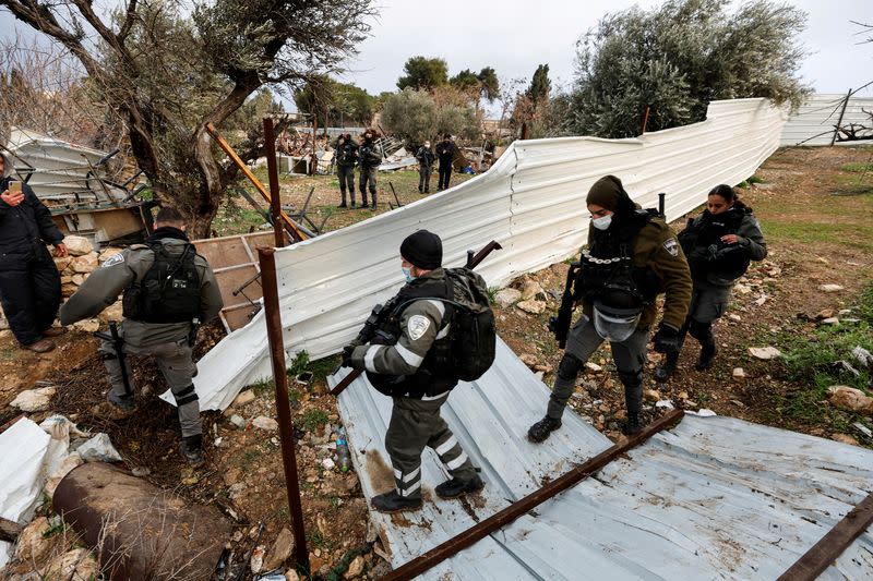 FILE PHOTO: Israeli security forces walk at the site of a demolished house in the Sheikh Jarrah neighbourhood of East Jerusalem