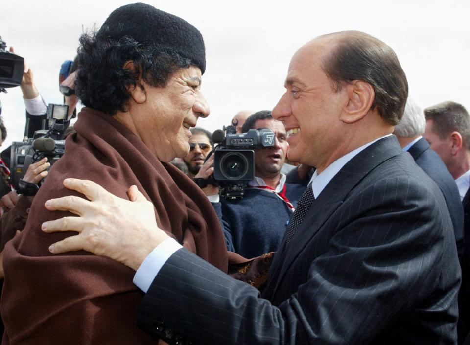 Libyan leader Muammar Gaddafi, left, greets Berlusconi during a meeting in Sirte on 10 February 2004 (AFP/Getty)