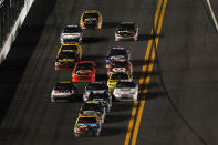 DAYTONA BEACH, FL - FEBRUARY 18: Kyle Busch, driver of the #18 M&M's Brown Toyota, leads a pack of cars during the NASCAR Budweiser Shootout at Daytona International Speedway on February 18, 2012 in Daytona Beach, Florida. (Photo by Jamie Squire/Getty Images)