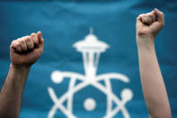 Volunteers hold their fists in the air during the March For Science in Seattle, Washington, U.S. April 22, 2017. REUTERS/David Ryder