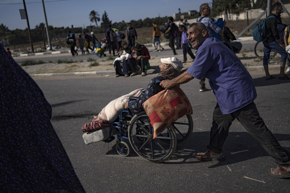 Palestinians flee to the southern Gaza Strip on Salah al-Din Street in Bureij, Gaza Strip, Friday, Nov. 10, 2023. (AP Photo/Fatima Shbair)