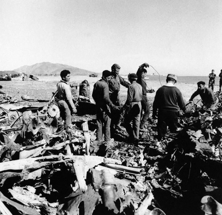 Spanish and Americans work together sorting the tons of wreckage from the B-52/KC-135 which crashed on the coast of Southern Spain on Feb. 22, 1966. (AP Photo)