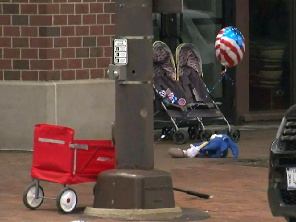 A child's stroller with a stars and stripes balloon attached is left after gunfire erupted at a Fourth of July parade route in the wealthy Chicago suburb of Highland Park, Illinois, U.S. July 4, 2022 in a still image from video. ABC affiliate WLS/ABC7 via REUTERS