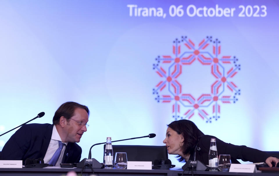 German Foreign Minister Annalena Baerbock, right, speaks with the EU Commissioner for Neighborhood and Enlargement Oliver Varhelyi during a summit in Tirana, Albania, Friday, Oct. 6, 2023. Foreign Ministers of the Western Balkans and the European Union member countries in the Berlin process, trying to raise up regional cooperation in their march toward becoming block members in the future, convene in Tirana to prepare the summit which is held in a non-EU member country. (AP Photo/Franc Zhurda)