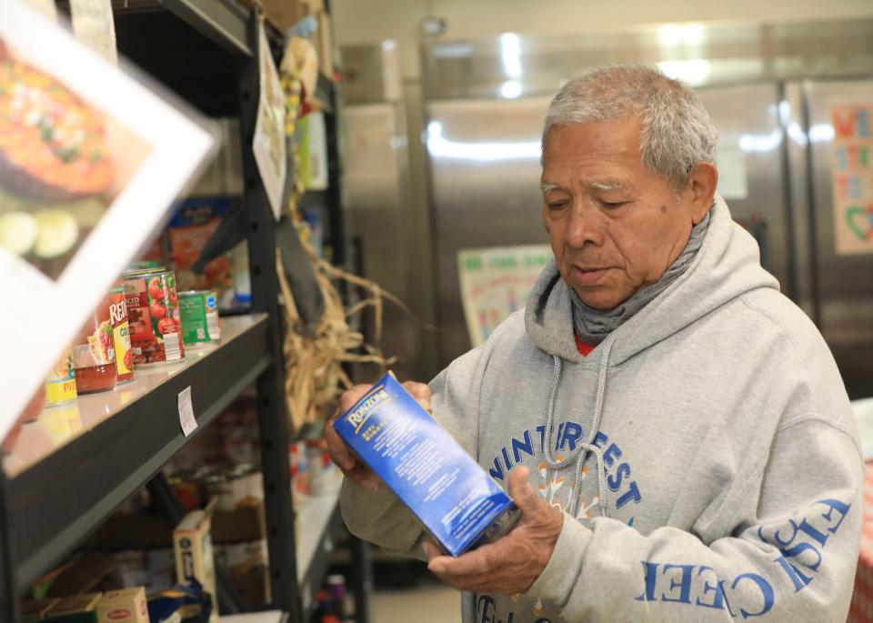 Dutchess Outreach food pantry volunteer Luis Mayorga stocks shelves on November 23, 2022.