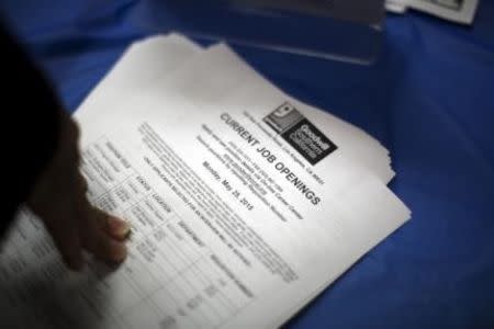 Job opening listings are distributed during a job fair for the homeless at the Los Angeles Mission in the Skid Row area of Los Angeles, California in this June 4, 2015 file photo. REUTERS/David McNew/Files