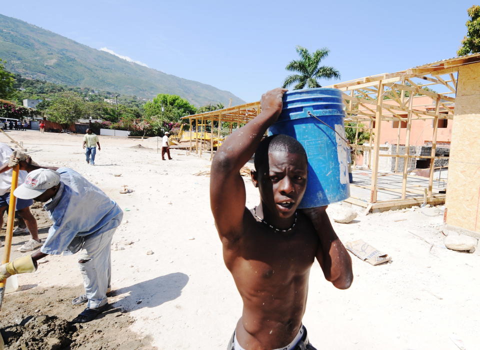 A young man helps&nbsp;rebuild the destroyed College St Jean l'Evangeliste on&nbsp;April 5, 2010.