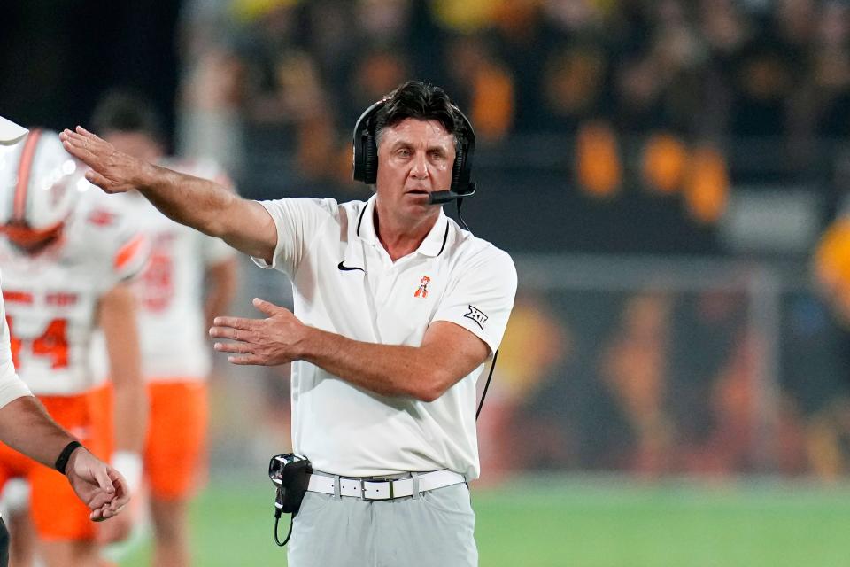 Oklahoma State coach Mike Gundy gestures from the sideline during the first half of the team's NCAA college football game against Arizona State on Saturday, Sept. 9, 2023, in Tempe, Ariz. (AP Photo/Ross D. Franklin)