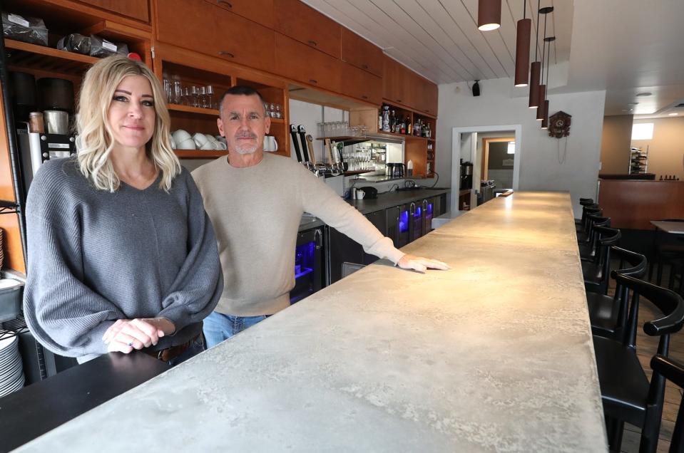 Jenn and Michael Bruno pose with the newly installed bar at the Blue Door Cafe & Bakery in Cuyahoga Falls.