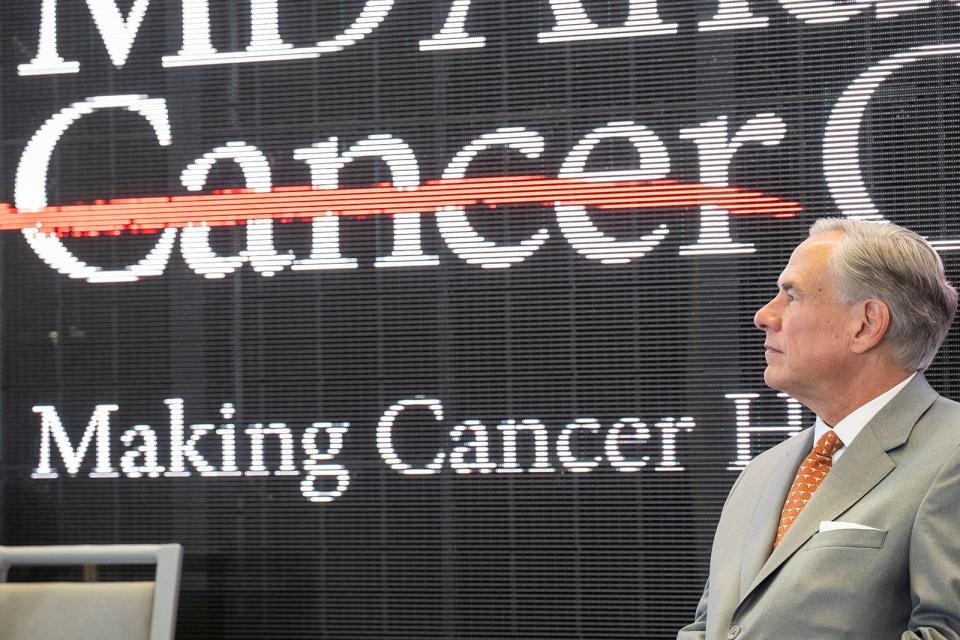 Gov. Greg Abbott watches as plans are announced Monday for a specialty hospital and a cancer center on the University of Texas campus in partnership with the MD Anderson Cancer Center. They will be built on the site of the Erwin Center.