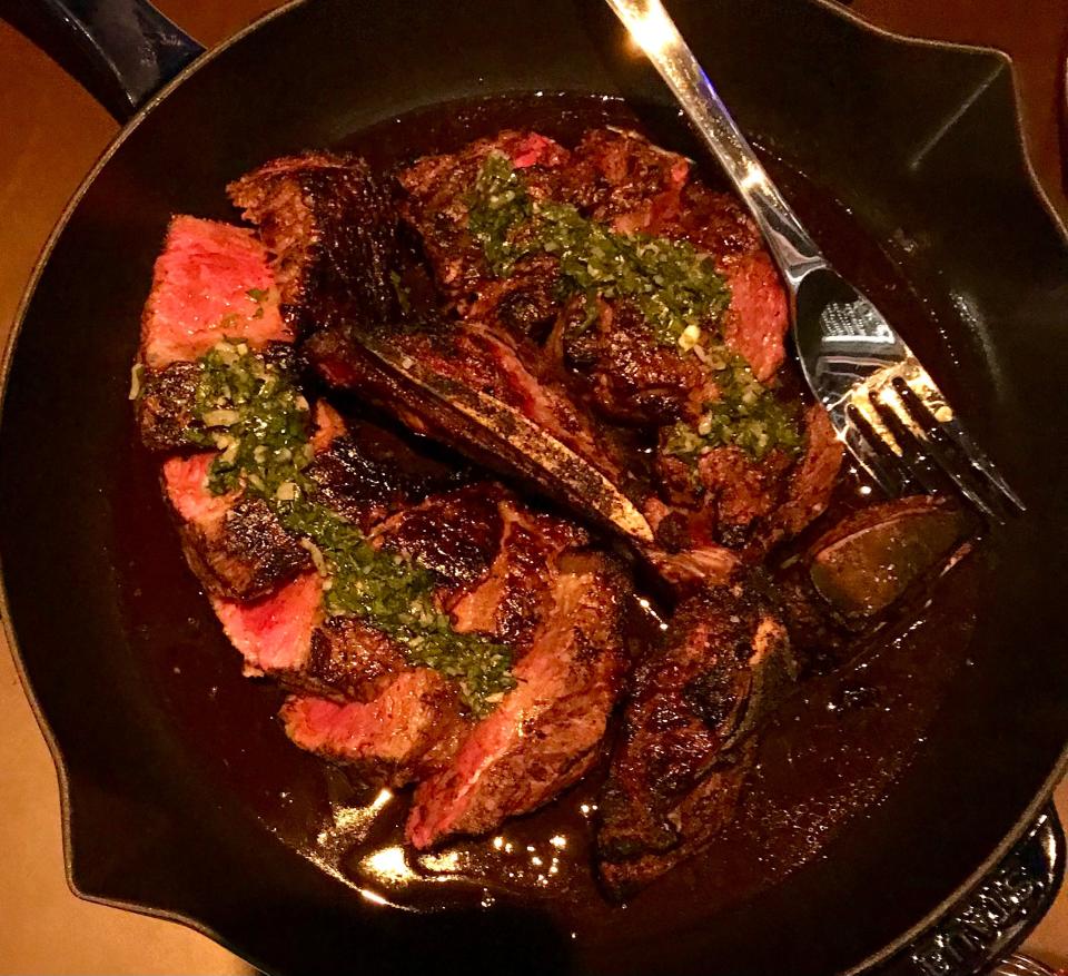 The 44-ounce, bone-in porterhouse steak for two at Lupi and Iris downtown is served with three side dishes.